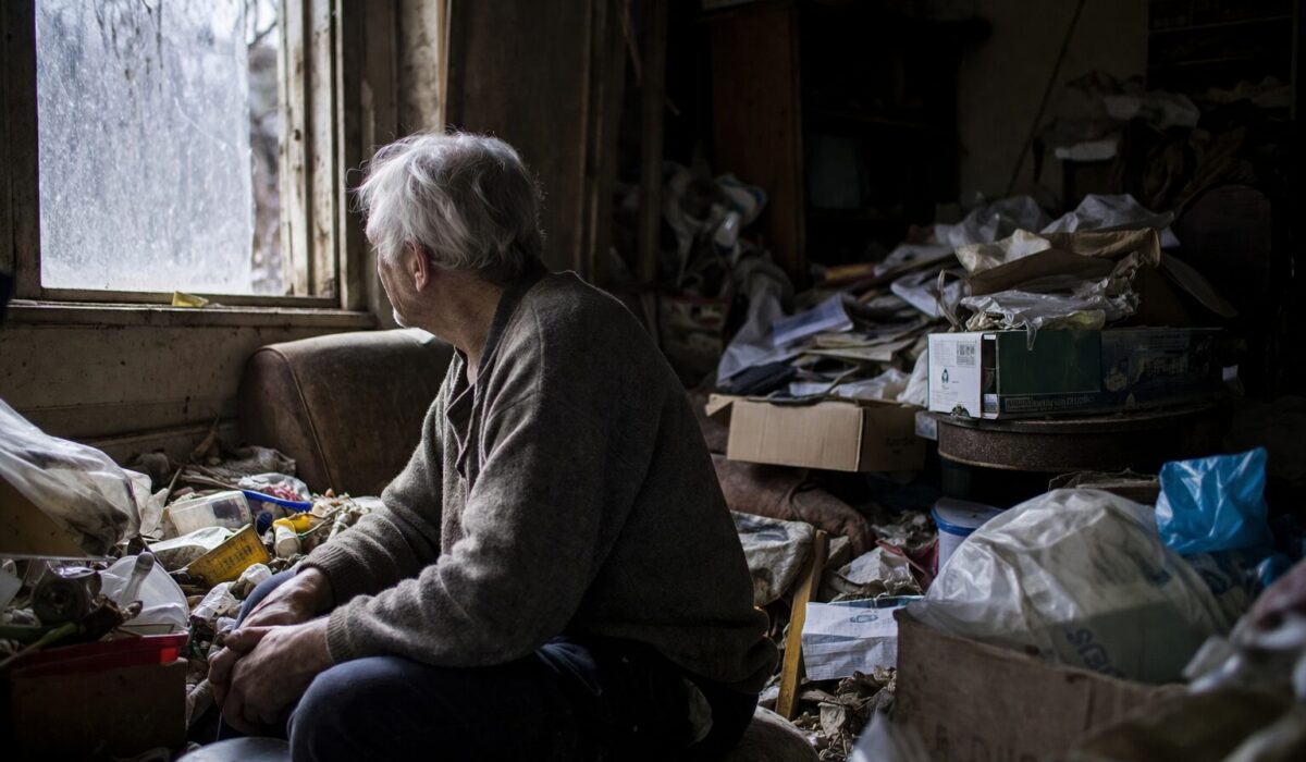 Patient âgé en situation d’isolement relationnel dans un logement très encombré, illustrant l’aggravation de l’incurie liée aux syndromes de Diogène, Noé ou Korsakoff